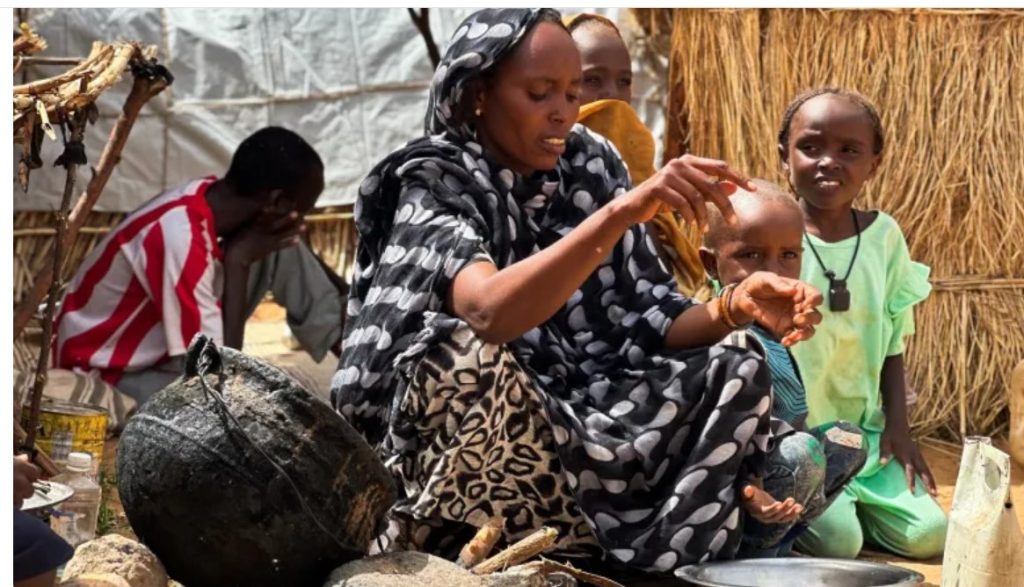 Houda Ali Mohammed, 32, a displaced Sudanese mother of four, prepares food at a camp in Tawila, North Darfur, Sudan, during the war between the paramilitary Rapid Support Forces a