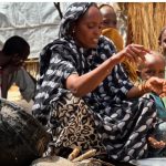 Houda Ali Mohammed, 32, a displaced Sudanese mother of four, prepares food at a camp in Tawila, North Darfur, Sudan, during the war between the paramilitary Rapid Support Forces a