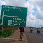 Photo; Journalist and author Natnael Gecho Betalo at the entrance to Kakuma Refugee Camp in Turkana County, Kenya.