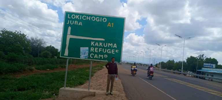 Photo; Journalist and author Natnael Gecho Betalo at the entrance to Kakuma Refugee Camp in Turkana County, Kenya.
