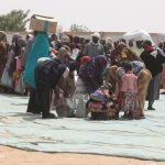 WFP-Asma Achahboun Sudanese refugees queue up for food at a distribution point in Adre, a Chadian town on the border with Sudan.