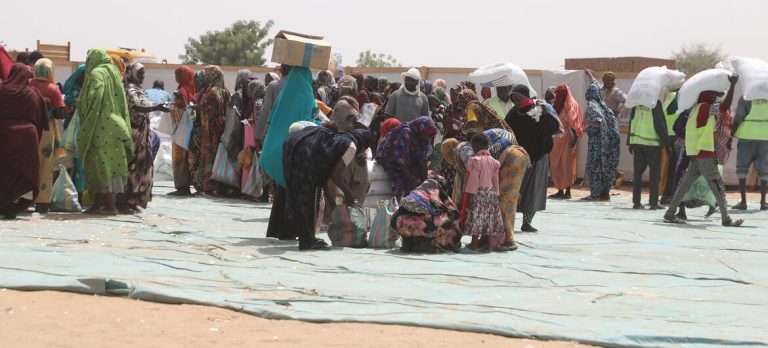 WFP-Asma Achahboun Sudanese refugees queue up for food at a distribution point in Adre, a Chadian town on the border with Sudan.
