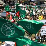 Muslim Brotherhood supporters wave flags in protest to denounce the US-led Middle East economic conference in Jordan last year Photo-Khalil Mazraawi