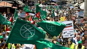 Muslim Brotherhood supporters wave flags in protest to denounce the US-led Middle East economic conference in Jordan last year Photo-Khalil Mazraawi